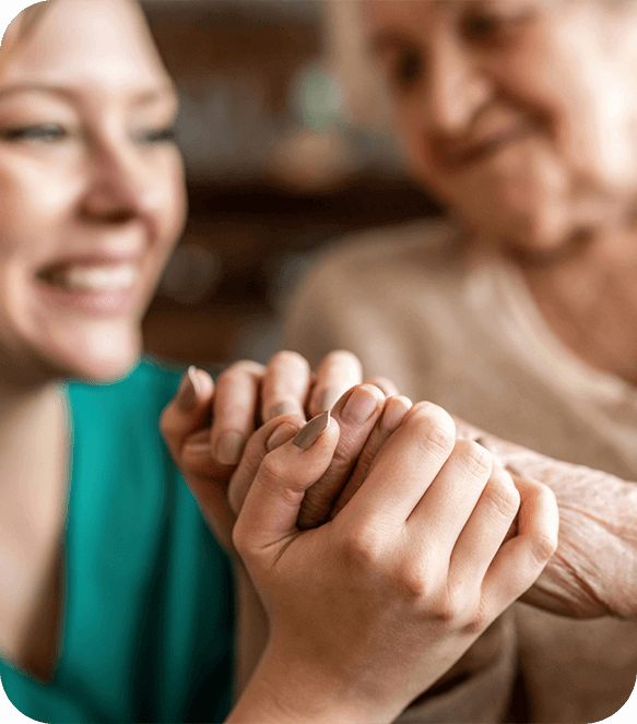 holding older patient's hand in hospice